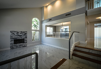 Stunning staircase and open living area after a complete home renovation in San Fernando.